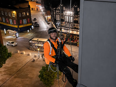 Allan Duffin, Managing Director, working at height in evening light