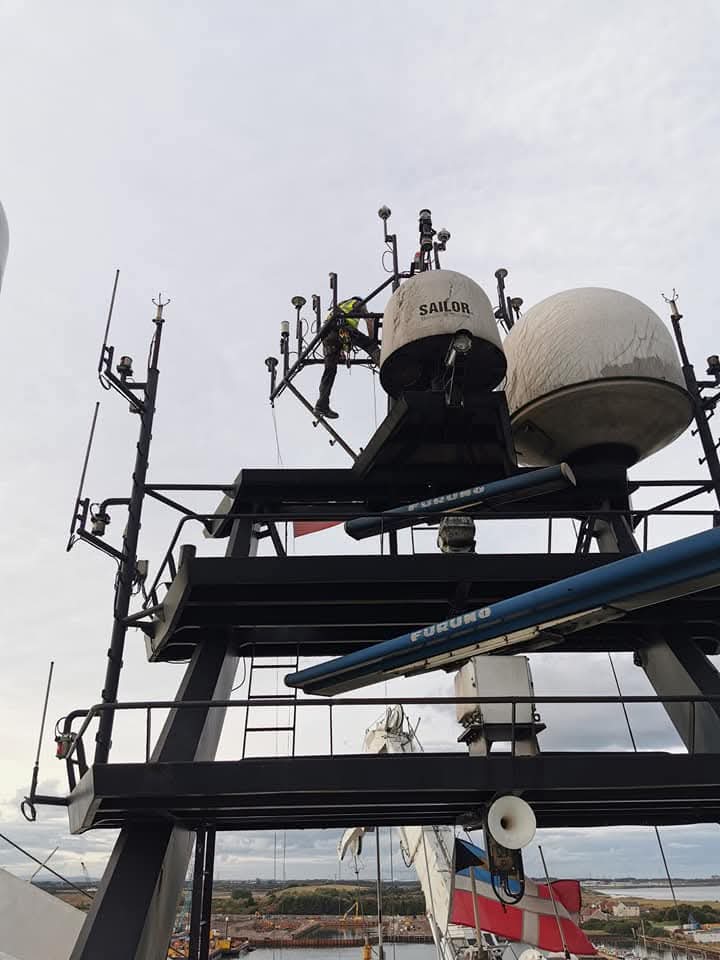Technician working among equipment on an elevated steel structure