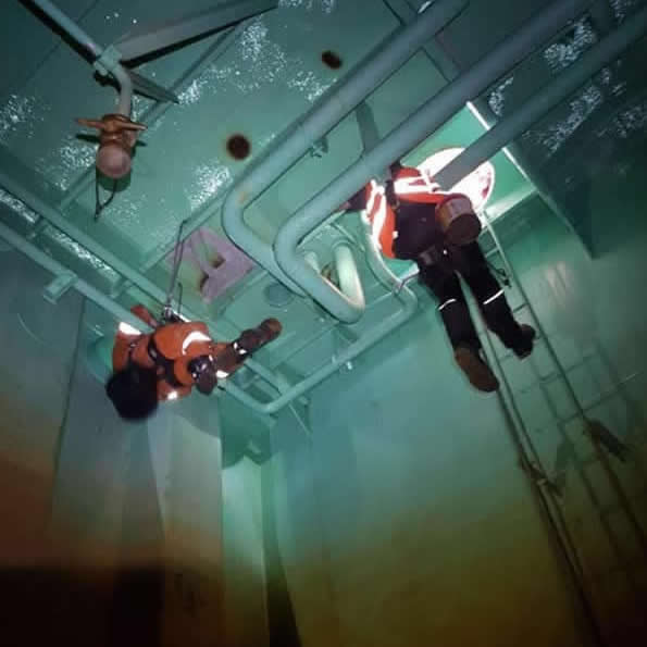 Confined space technician carrying out repairs inside a ship's ballast tank
