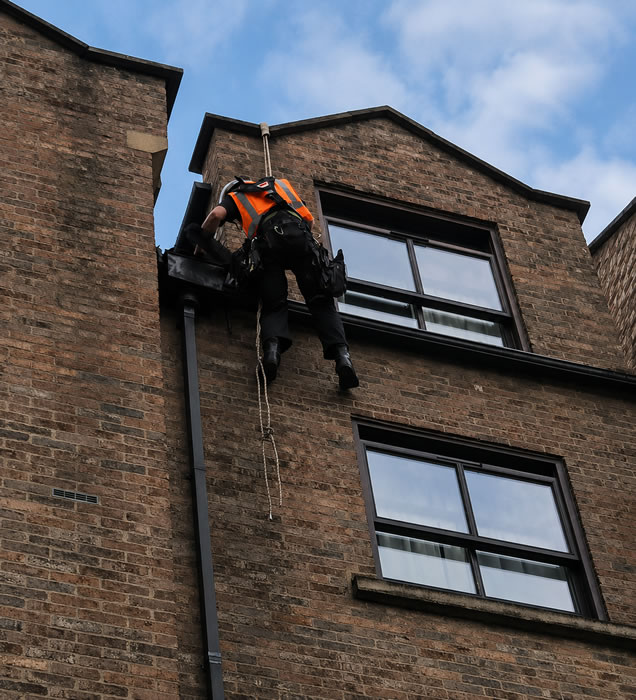 Technician carrying out guttering maintenance